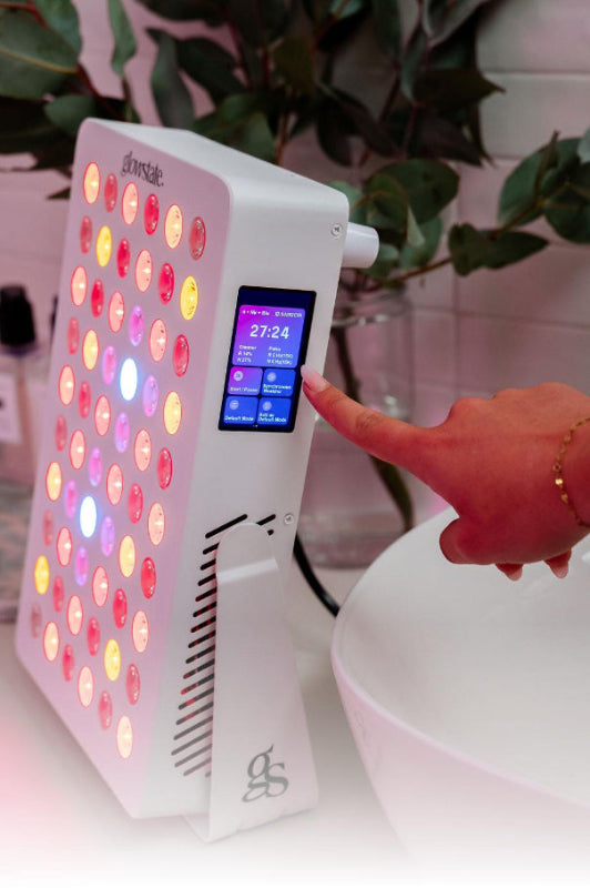 Radiance60 red light panel touchscreen used by a lady, the panel placed on benchtop, glowing LEDs, the bottom of image fades