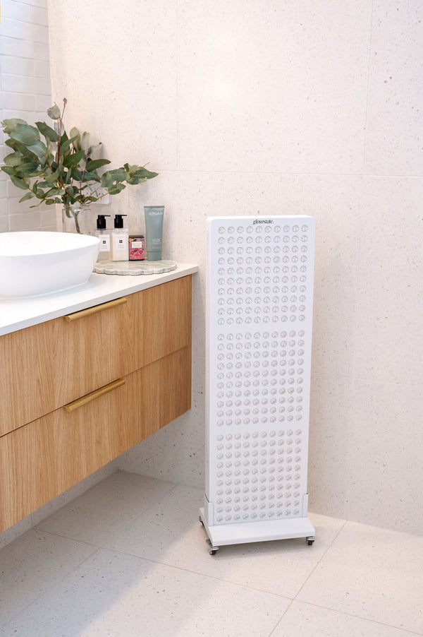 The Radiance300 red light panel in bathroom on a mobile stand, the panel is higher than the bench top.