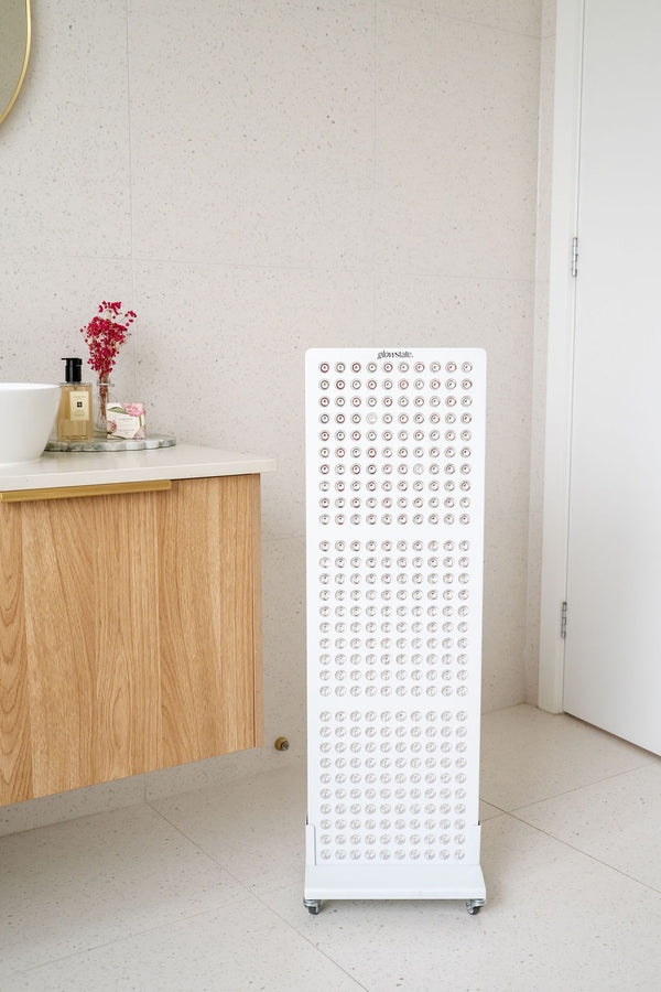 The Radiance300 red light panel in bathroom on a mobile stand, the 300 LEDs are showing.