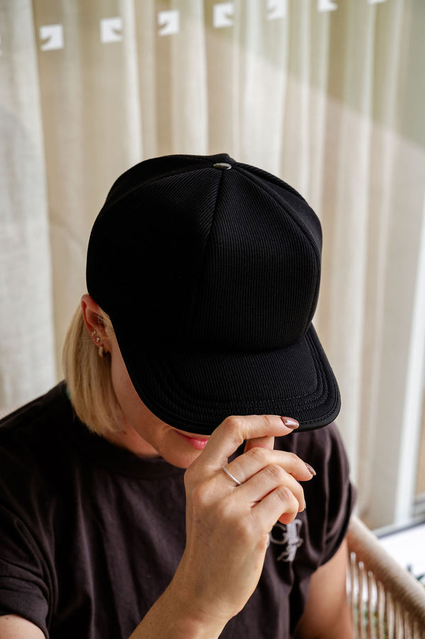 The Halo red light therapy cap is being placed on a lady's head.