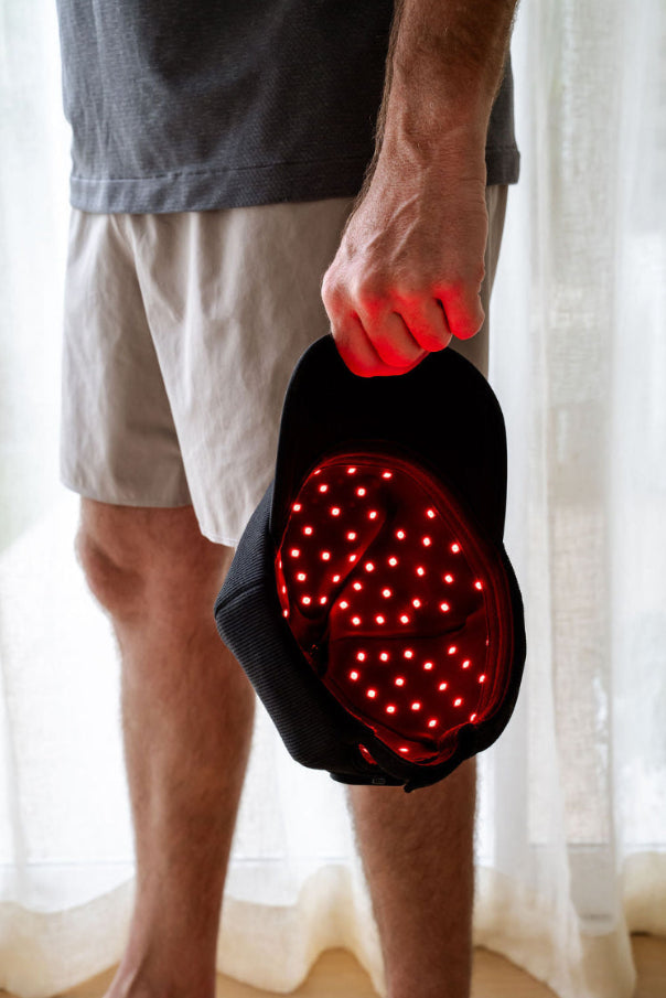 The Halo red light therapy cap showing the inside section with glowing LEDs on.