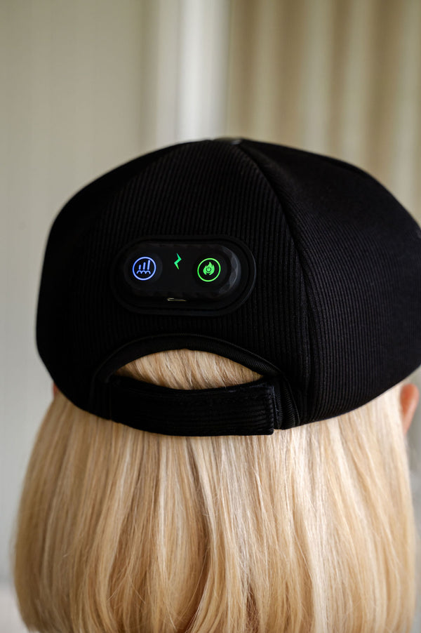 The Halo red light therapy cap control panel shown from the back of a lady's head.