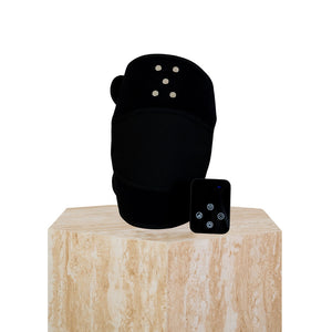 The Focus Flex Joint Wrap, a flexible red light therapy joint wrap, sitting on a plinth showing the removable control panel.