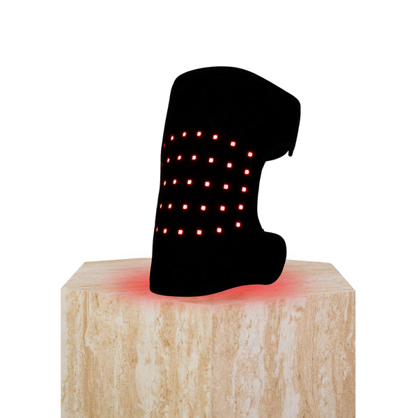 The Focus Flex Joint Wrap, a flexible red light therapy joint wrap, on a plinth showing the inside view and LEDs glowing.